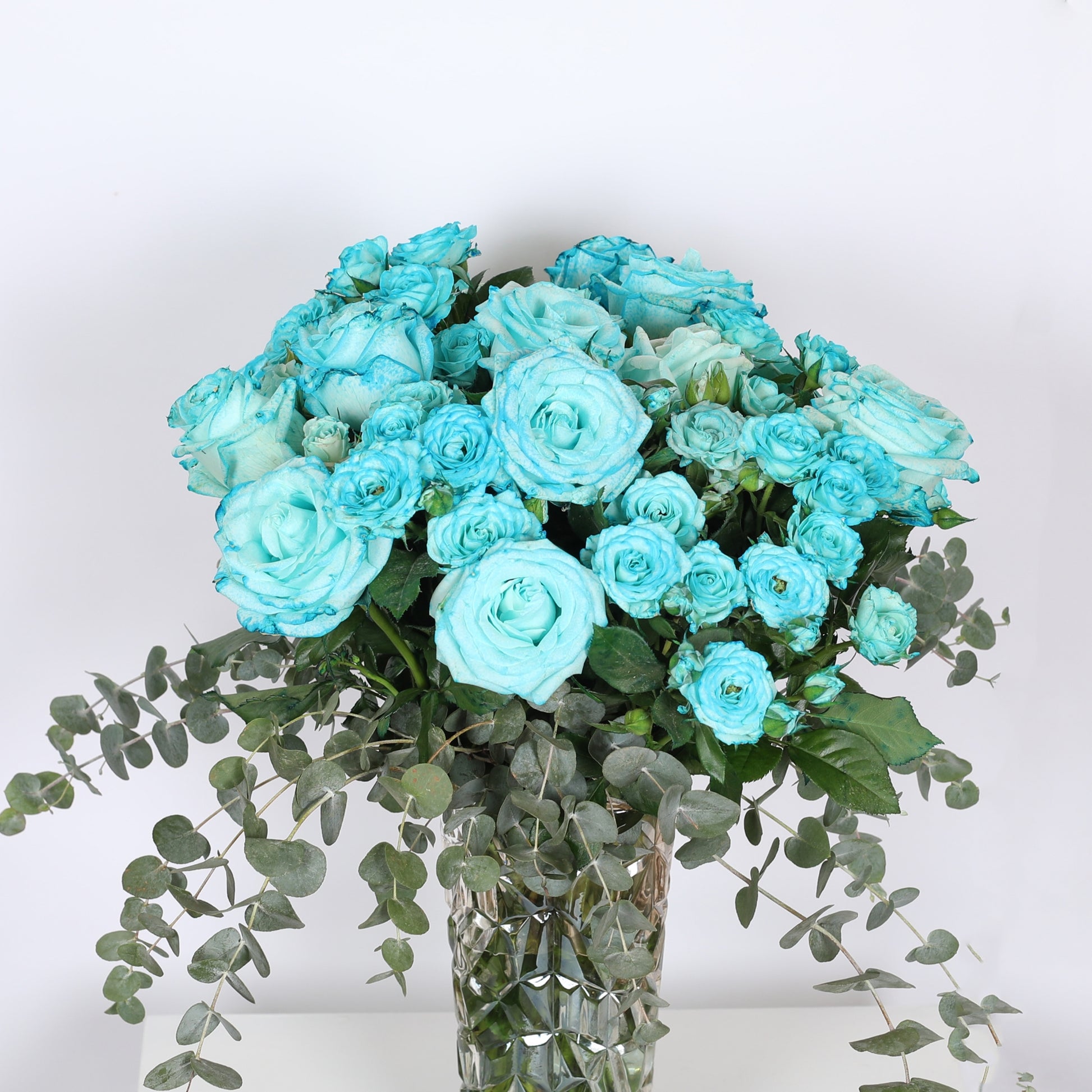 Blossoms in Harmony:  The Dance of the Blue Rose and Eucalyptus.