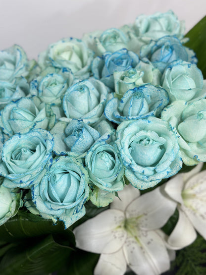 Blue Roses and White Lilies in a White Box.