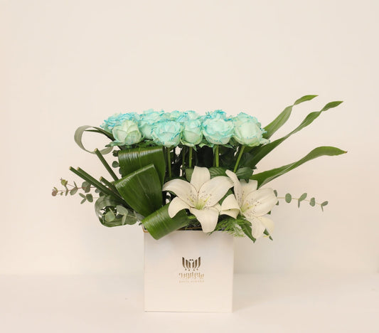 Blue Roses and White Lilies in a White Box.